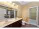 Bathroom with double vanity, a framed mirror, a walk-in closet, and tile floors at 2412 Country Pond Ct, St Cloud, FL 34771