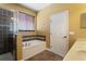 Bright bathroom featuring a soaking tub with decorative tile surround and a glass-enclosed shower at 2412 Country Pond Ct, St Cloud, FL 34771