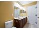 Bathroom featuring dual sinks, wood vanity, and tiled floors at 2412 Country Pond Ct, St Cloud, FL 34771