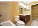 Bright bathroom featuring double vanity, ceramic tile, bathtub, and walk-in closet for ample storage at 2412 Country Pond Ct, St Cloud, FL 34771