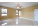 Neutral bedroom with a ceiling fan, three windows with blinds, and tile floors at 2412 Country Pond Ct, St Cloud, FL 34771