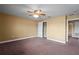 Bedroom with a ceiling fan, closet, neutral paint, carpet, and a doorway at 2412 Country Pond Ct, St Cloud, FL 34771