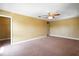 Spacious bedroom with a ceiling fan and attached walk-in closet for optimal storage at 2412 Country Pond Ct, St Cloud, FL 34771