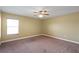 Well-lit bedroom offering ample space with a ceiling fan and window at 2412 Country Pond Ct, St Cloud, FL 34771