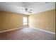 Bedroom featuring a ceiling fan, neutral paint, carpet, and natural light from a window at 2412 Country Pond Ct, St Cloud, FL 34771