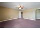 Bedroom with tan walls, plush carpet and a view to the hallway at 2412 Country Pond Ct, St Cloud, FL 34771