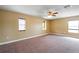 Spacious carpeted bedroom with natural light and ceiling fan offers comfort at 2412 Country Pond Ct, St Cloud, FL 34771
