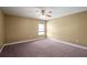 This bedroom has neutral walls and carpet with one window and a ceiling fan at 2412 Country Pond Ct, St Cloud, FL 34771