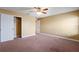 Bedroom with a closet, neutral paint, ceiling fan, carpet, and a doorway at 2412 Country Pond Ct, St Cloud, FL 34771