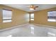 A bright room with large windows, neutral walls, tile floors, and a ceiling fan at 2412 Country Pond Ct, St Cloud, FL 34771