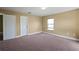 This bedroom has neutral walls and carpet with one window for natural light at 2412 Country Pond Ct, St Cloud, FL 34771