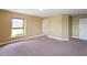 Bedroom with neutral paint, plush carpet, a window, and a white door at 2412 Country Pond Ct, St Cloud, FL 34771