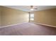 Spacious bedroom featuring neutral walls, plush carpeting, and a ceiling fan for added comfort at 2412 Country Pond Ct, St Cloud, FL 34771