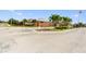Community entrance featuring brick signage with manicured landscaping and an American flag at 2412 Country Pond Ct, St Cloud, FL 34771