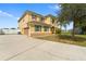 Exterior elevation of a two-story house featuring a large manicured lawn and extended driveway at 2412 Country Pond Ct, St Cloud, FL 34771