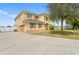 Two-story home featuring a two-car garage, green shutters, a manicured lawn, and a large driveway at 2412 Country Pond Ct, St Cloud, FL 34771