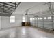 Spacious garage with overhead storage racks and a large garage door with windows at 2412 Country Pond Ct, St Cloud, FL 34771