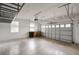 Spacious garage with overhead storage racks and a large garage door with windows at 2412 Country Pond Ct, St Cloud, FL 34771