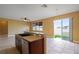 Bright kitchen island overlooking the living area and private backyard at 2412 Country Pond Ct, St Cloud, FL 34771