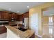Gourmet kitchen featuring dark wood cabinets, stainless steel appliances, and granite countertops at 2412 Country Pond Ct, St Cloud, FL 34771