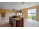 Open kitchen island with bar seating, seamlessly connects to a spacious living area at 2412 Country Pond Ct, St Cloud, FL 34771