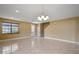 Bright living room features sleek tile flooring and modern chandelier lighting at 2412 Country Pond Ct, St Cloud, FL 34771