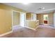Upstairs loft area featuring carpet and access to additional rooms and bathrooms at 2412 Country Pond Ct, St Cloud, FL 34771