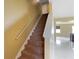 Carpeted staircase leading to the upper level with natural light from nearby windows at 2412 Country Pond Ct, St Cloud, FL 34771