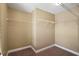 A walk-in closet features tan walls and metal shelving for maximum storage at 2412 Country Pond Ct, St Cloud, FL 34771