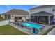 Backyard features a pool, covered patio and swing, and a screened-in lanai at 2473 Biscotto Cir, Davenport, FL 33897