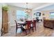 An elegant dining room features a sophisticated table setting with a view into the cozy living area at 2473 Biscotto Cir, Davenport, FL 33897