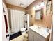 Bright bathroom featuring a toilet, a shower-tub combo, and a white vanity sink with modern lighting at 268 Florida Pkwy, Kissimmee, FL 34743
