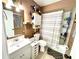 Functional bathroom featuring a vanity sink, a mirror, a toilet, and a shower-tub combo at 268 Florida Pkwy, Kissimmee, FL 34743