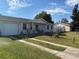 Exterior view of house with driveway and detached garage at 268 Florida Pkwy, Kissimmee, FL 34743