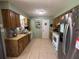 Bright kitchen featuring classic wood cabinets, stainless steel appliances, and a tile backsplash at 268 Florida Pkwy, Kissimmee, FL 34743