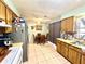 Bright kitchen featuring classic wood cabinets, a ceiling fan, and adjacent dining area with breakfast table set at 268 Florida Pkwy, Kissimmee, FL 34743