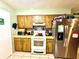 Functional kitchen with wood cabinets, appliances, and tiled backsplash at 268 Florida Pkwy, Kissimmee, FL 34743