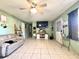 Inviting living room with neutral tile floors, ceiling fan, and comfortable seating at 268 Florida Pkwy, Kissimmee, FL 34743