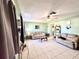 Inviting living room with tile flooring, comfortable couches, and ladder shelving at 268 Florida Pkwy, Kissimmee, FL 34743