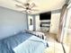 Comfortable main bedroom with tile floors, a ceiling fan, and a sliding glass door with view of the backyard at 268 Florida Pkwy, Kissimmee, FL 34743