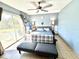 Relaxing main bedroom with a ceiling fan and a sliding glass door that lets in natural light at 268 Florida Pkwy, Kissimmee, FL 34743