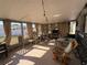 This is a bright enclosed porch, with tile flooring, string lights, and outdoor seating at 268 Florida Pkwy, Kissimmee, FL 34743
