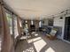 Relax on this enclosed porch, which includes tile floors, string lights, and outdoor seating at 268 Florida Pkwy, Kissimmee, FL 34743