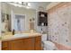 Bathroom featuring a vanity with a sink, toilet, shower curtain, and cabinet storage at 3686 Ricky Ln, St Cloud, FL 34772