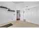 Bright bedroom featuring two closets, decorative shelves, neutral carpet, and a view of an adjacent room at 3686 Ricky Ln, St Cloud, FL 34772