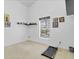 Minimalist bedroom with high ceilings, a treadmill, sleek decor, and bright natural light at 3686 Ricky Ln, St Cloud, FL 34772