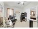 Bright bedroom with a ceiling fan, window, desk, chair, and closet, providing ample space at 3686 Ricky Ln, St Cloud, FL 34772