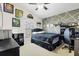 Bedroom with unique gray accent wall, decorative shelving, and dark furniture, plus a ceiling fan at 3686 Ricky Ln, St Cloud, FL 34772