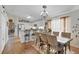 Bright dining room with wooden floors, views of the kitchen, and a dining table set for a meal at 3686 Ricky Ln, St Cloud, FL 34772