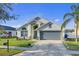 Well-maintained single-story home with a two-car garage and verdant front yard at 3686 Ricky Ln, St Cloud, FL 34772